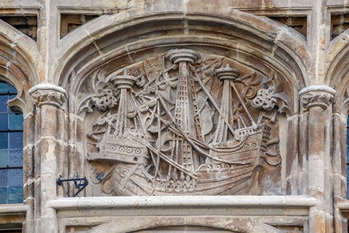 Stone relief carving of a medieval sailing ship on the facade of the Ghent Free Boatmen's Guild House (Gildenhuis van de Vrije Schippers) in Ghent, Belgium.  The carving depicts a type of medieval commerce ship, highlighting the importance of the wool trade to the city's wealth in the late medieval period. 